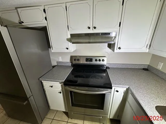 a kitchen with stainless steel appliances a stove a microwave and cabinets