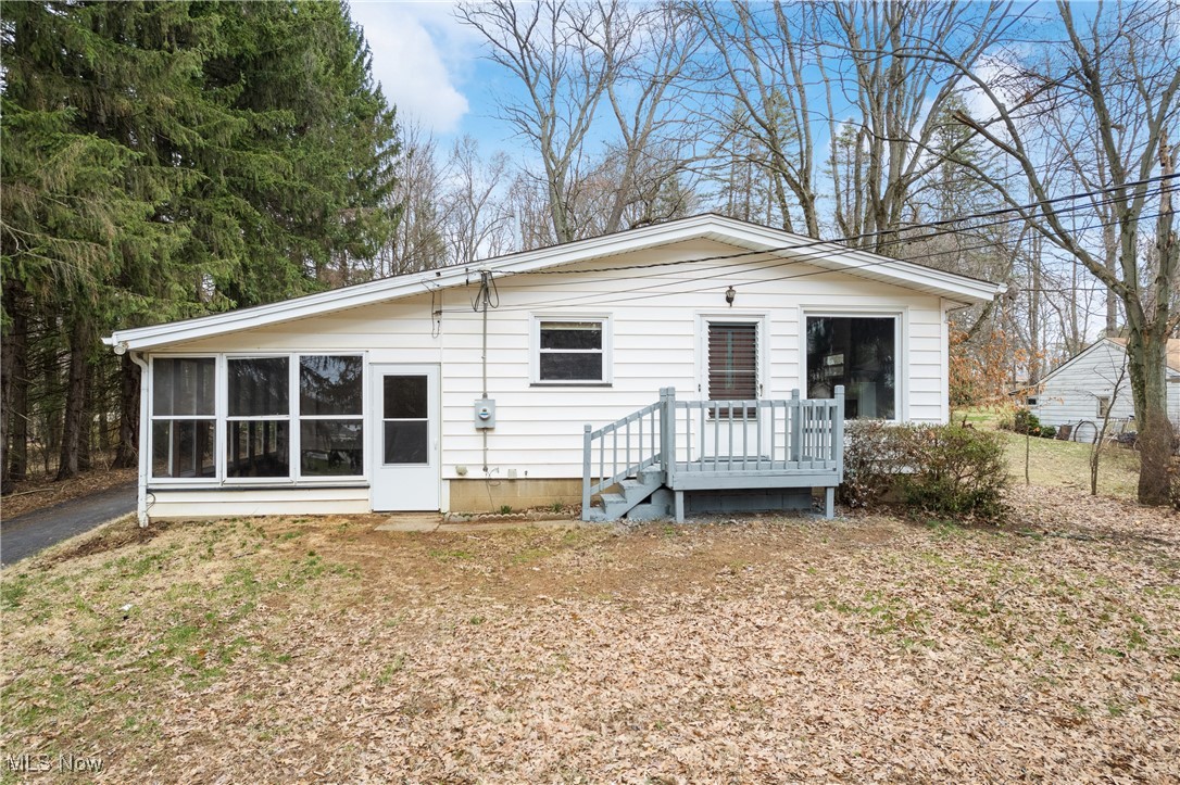 Front of property with a sunroom