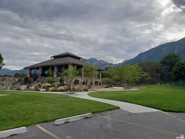 3 Carriagewood Cove, Unit 1088 Sandy, UT 84092 - Photo 73 of 79 Stone-clad pavilion with a multi-tiered roofline, featuring an expansive lawn area and concrete pathways