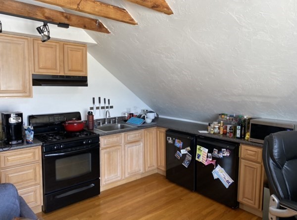6 School Street, Unit 3 Chelsea, MA 02150 - Photo 2 of 10 a kitchen with stainless steel appliances a stove and cabinets