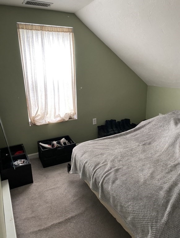 6 School Street, Unit 3 Chelsea, MA 02150 - Photo 8 of 10 a bedroom with a bed and a couch