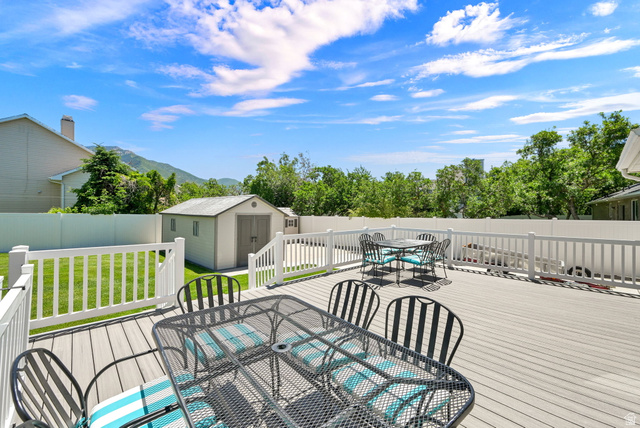4792 Glasmann Way South Ogden, UT 84403 - Photo 20 of 70 Spacious outdoor deck featuring composite decking, white railing with gate to hot tub, and stairs to a fenced yard