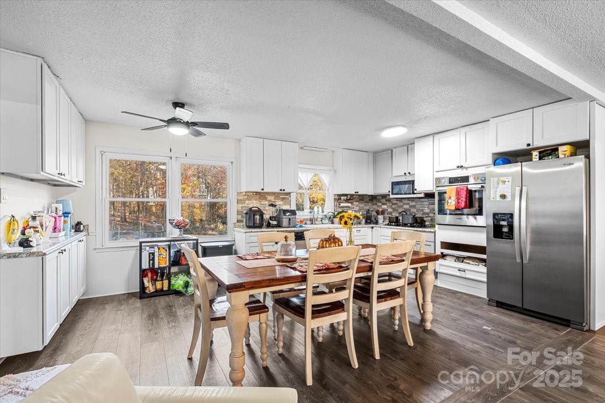 1241 Red River Road Rock Hill, SC 29730 - Photo 9 of 24 a kitchen with stainless steel appliances a dining table chairs refrigerator and cabinets