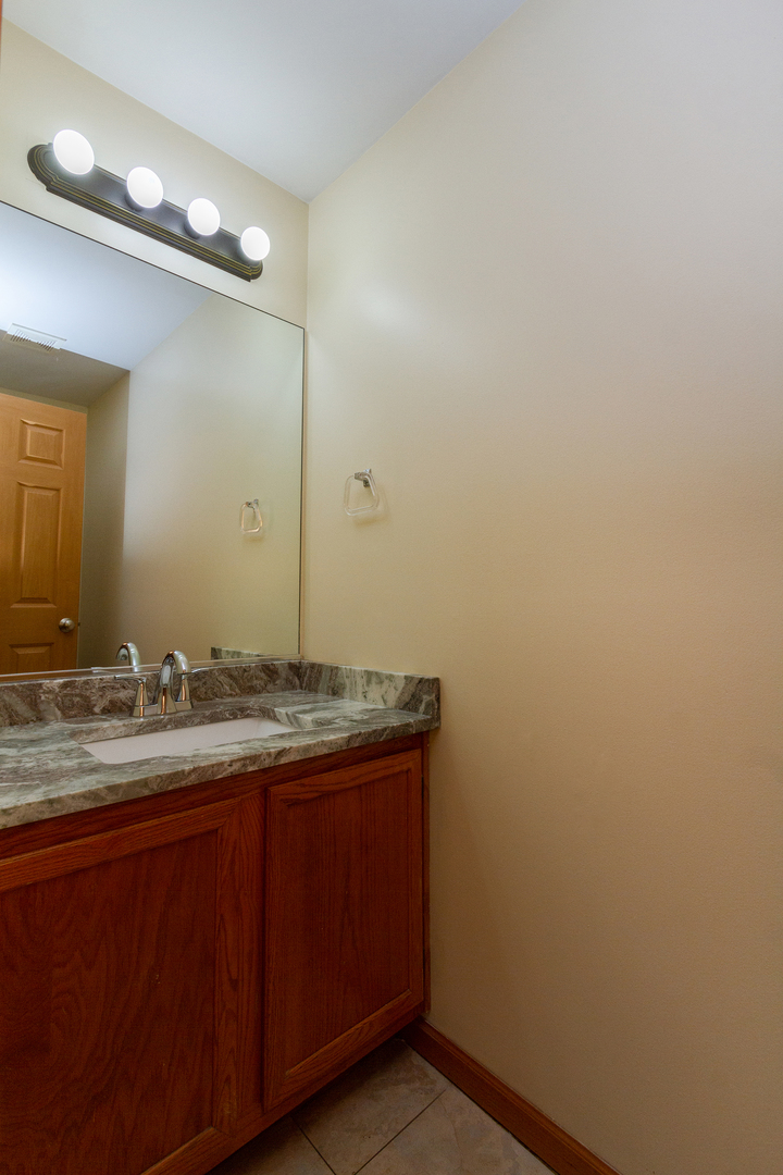 2624 Idaho Road Naperville, IL 60564 - Photo 11 of 23 a bathroom with a granite countertop sink and a mirror
