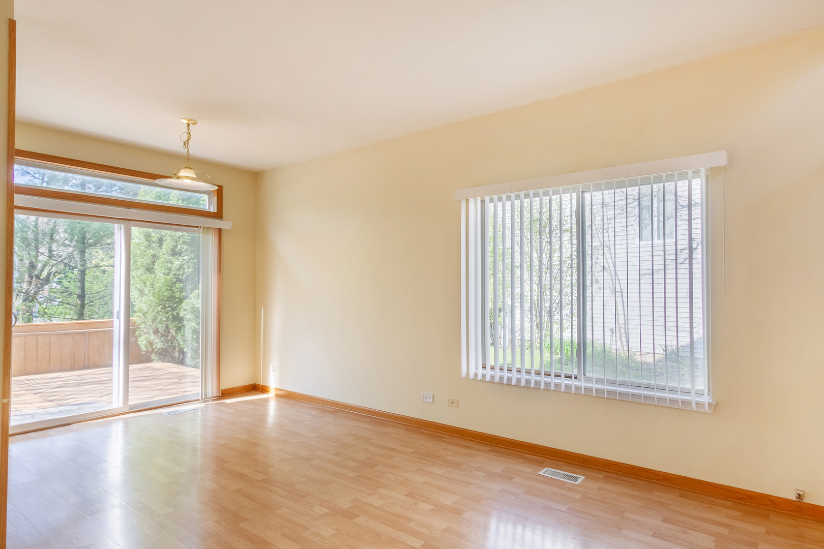 2624 Idaho Road Naperville, IL 60564 - Photo 2 of 23 a view of an empty room with wooden floor and a window
