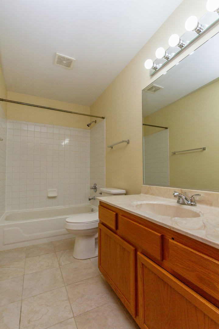2624 Idaho Road Naperville, IL 60564 - Photo 21 of 23 a bathroom with a granite countertop sink a toilet and shower