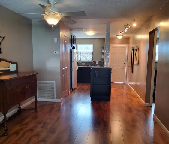 a room with wooden floors and furniture