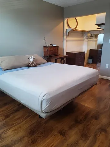 a bedroom with a bed and a mirror