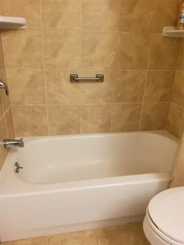 a bathroom with a bathtub and a toilet