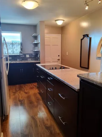 a kitchen with a sink and large window