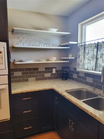 a kitchen with a sink and wooden cabinets