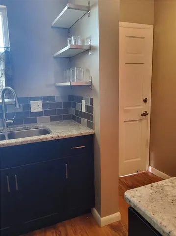 a kitchen with a sink and cabinets