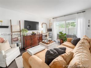 4590 Southwest 68th Ct Circle, Unit 8 Miami, FL 33155 - Photo 5 of 11 a living room with furniture and a large window