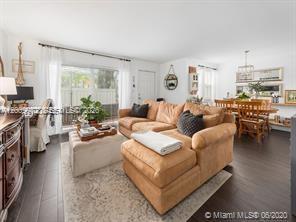 4590 Southwest 68th Ct Circle, Unit 8 Miami, FL 33155 - Photo 6 of 11 a living room with furniture and a large window