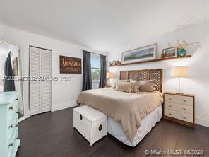 4590 Southwest 68th Ct Circle, Unit 8 Miami, FL 33155 - Photo 10 of 11 a bedroom with a bed and a night stand