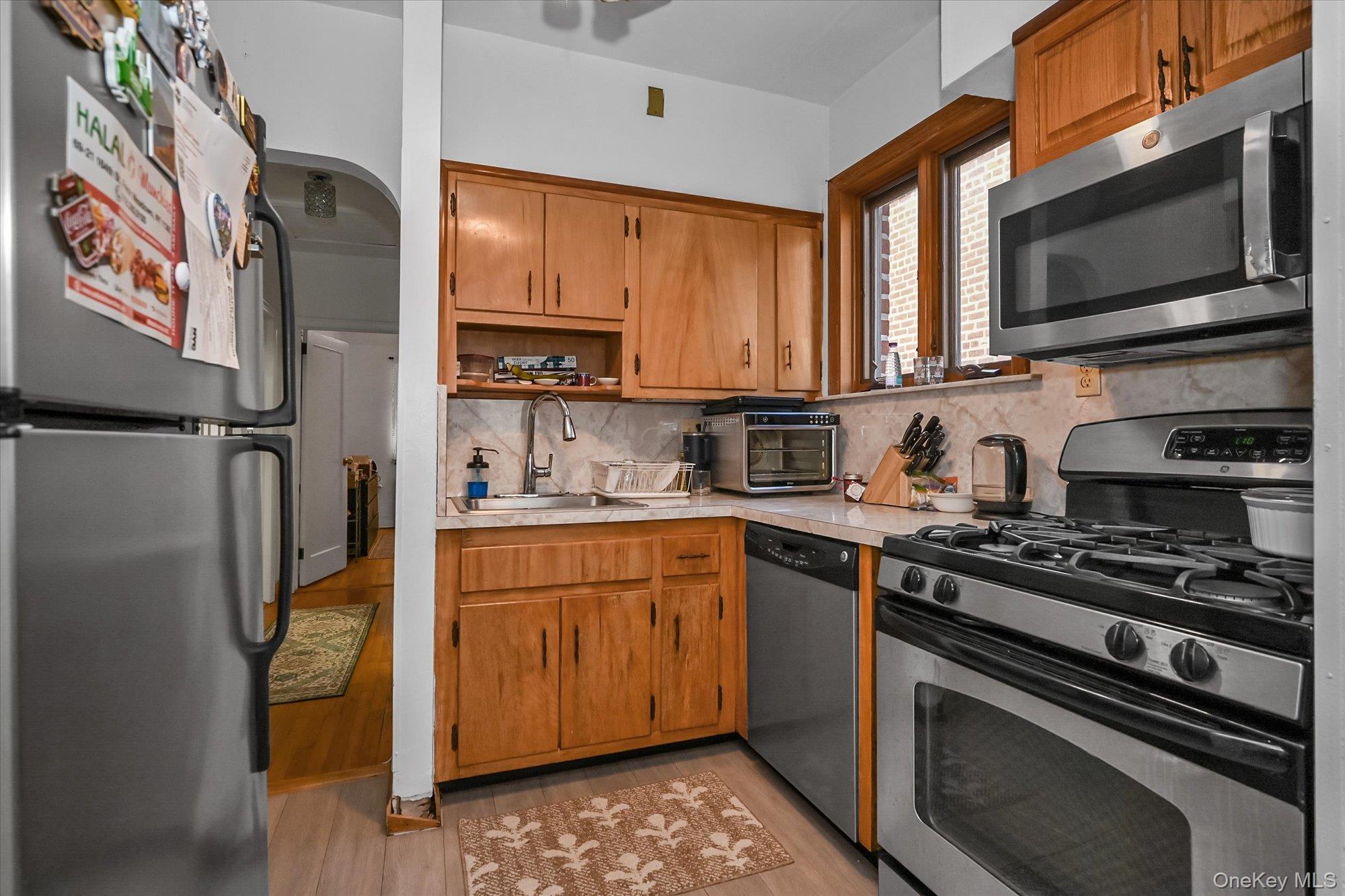53-08 193rd Street Queens, NY 11365 - Photo 6 of 17 a kitchen with stainless steel appliances a stove a sink and a refrigerator