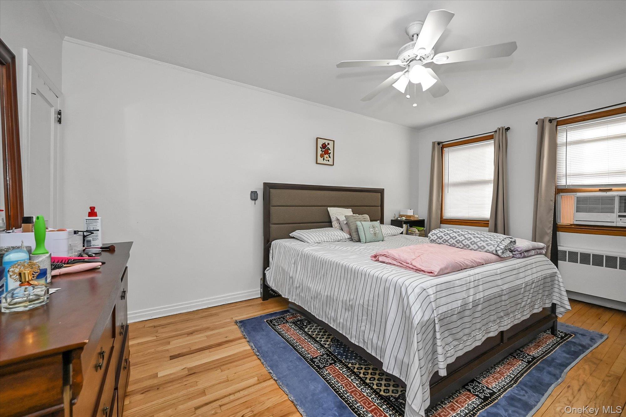 53-08 193rd Street Queens, NY 11365 - Photo 8 of 17 a bedroom with a bed a table and chair