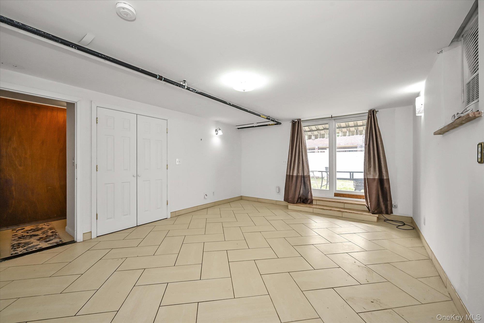 53-08 193rd Street Queens, NY 11365 - Photo 10 of 17 a view of an empty room with a window