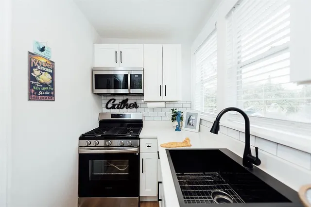 a kitchen with a stove and a sink