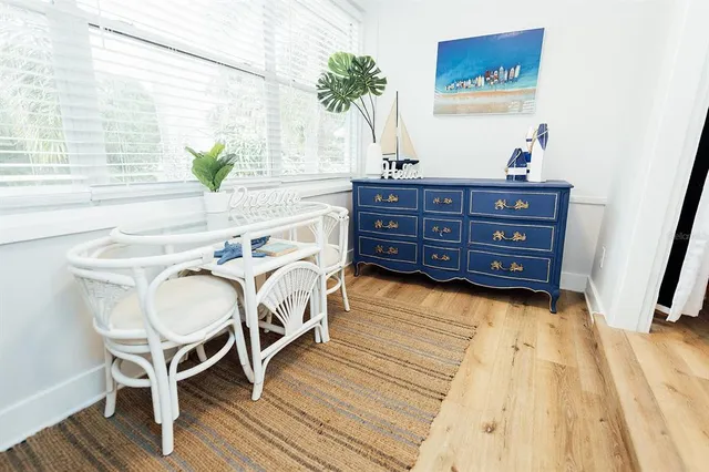 a bed sitting in a spacious bedroom next to a window