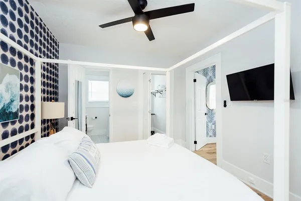 a bedroom with a bed and a flat screen tv