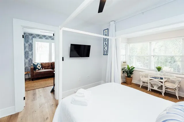 a bedroom with furniture and a flat screen tv