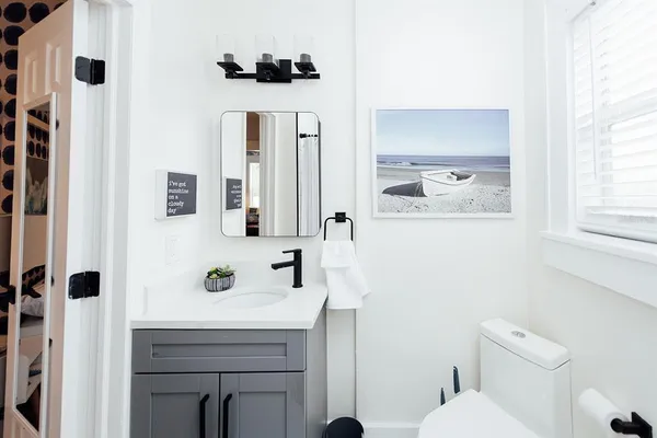 a bathroom with a sink a toilet and shower
