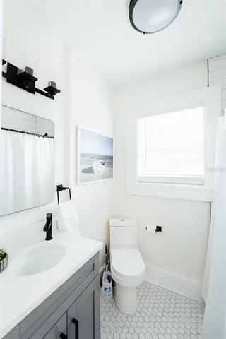 a bathroom with a sink toilet and vanity