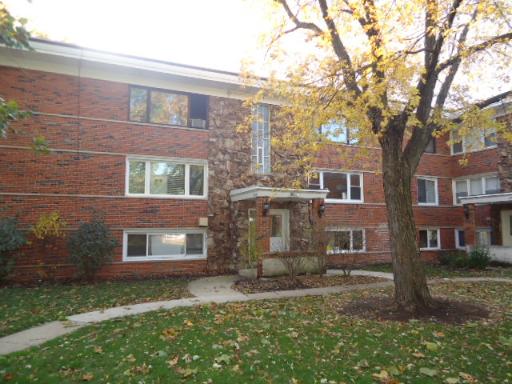 a view of a brick building next to a yard