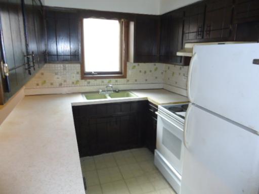 6834 West Lode Drive, Unit 1B Worth, IL 60482 - Photo 4 of 6 a kitchen with a sink and a refrigerator