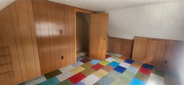 a room with a rug and a window