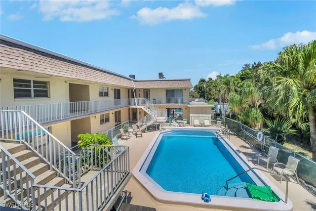 a view of house with swimming pool outdoor seating