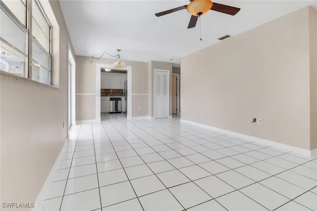a view of a livingroom with a ceiling fan and window
