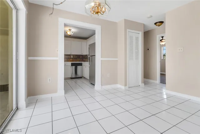 a view of a kitchen with a refrigerator and a stove top oven