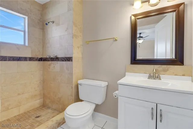 a bathroom with a toilet a sink and a mirror