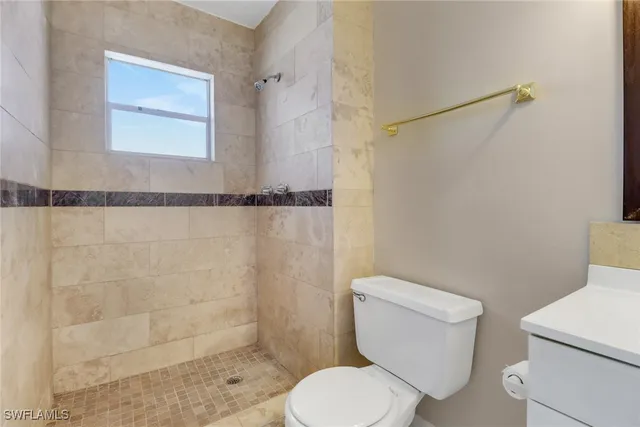 a white toilet sitting next to a bathroom sink