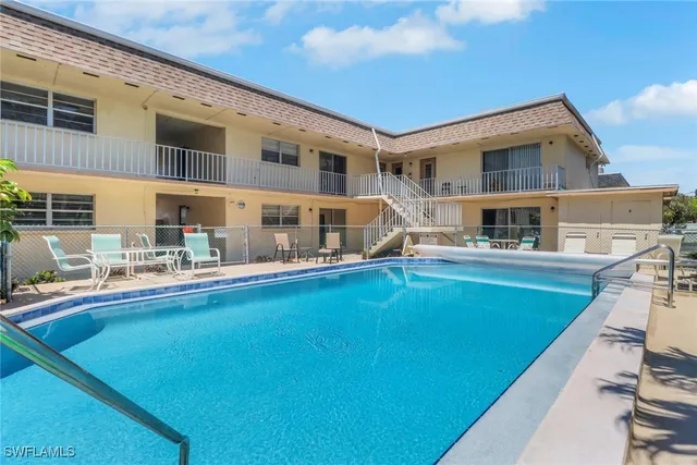 a view of house with swimming pool outdoor seating