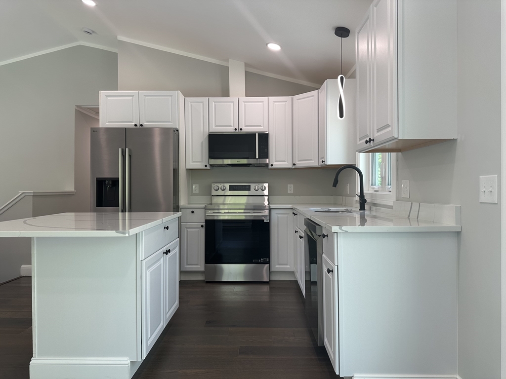 102 Wells Road Becket, MA 01223 - Photo 13 of 40 a kitchen with stainless steel appliances a stove refrigerator sink and microwave