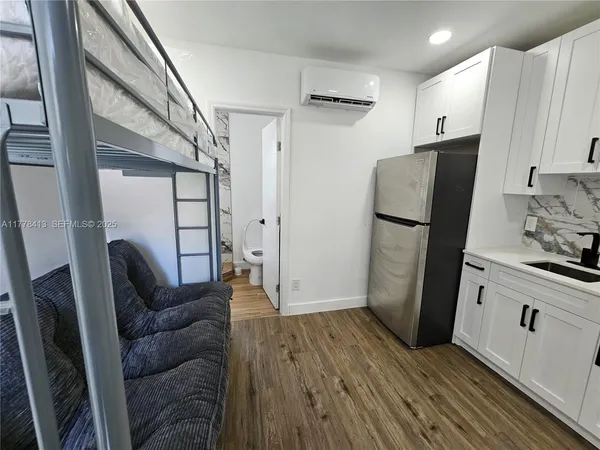 a view of kitchen with furniture and wooden floor