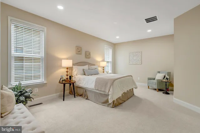 a bathroom with a granite countertop tub sink and mirror