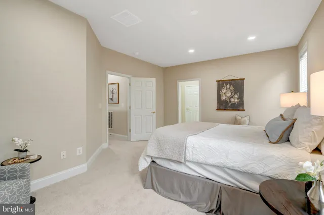 a bathroom with a tub a double vanity sink and mirror