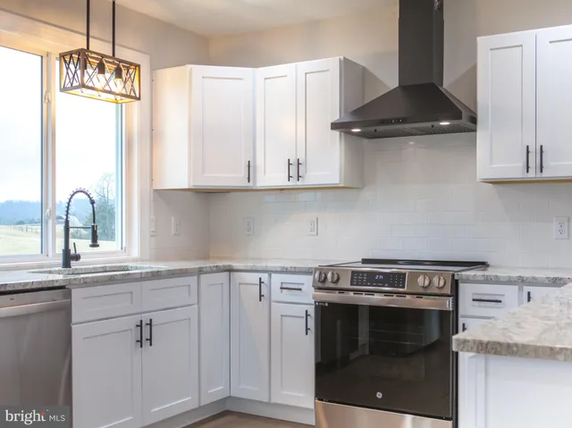 a kitchen with a stove and a sink