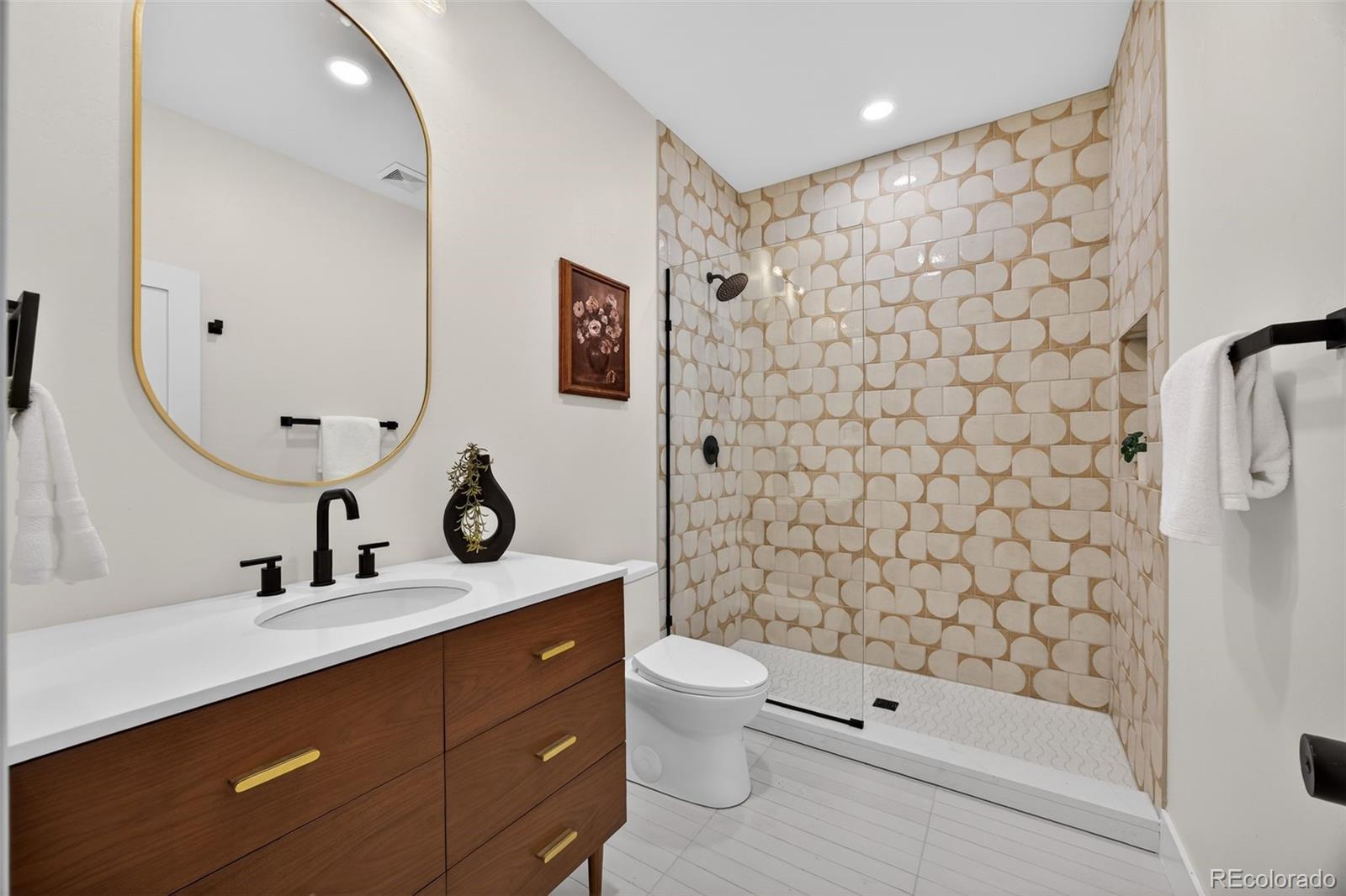 5175 Raleigh Street Denver, CO 80212 - Photo 35 of 49 a bathroom with a sink a toilet and shower