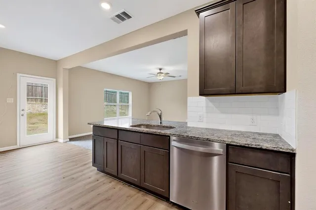 a spacious bathroom with a granite countertop sink and mirror