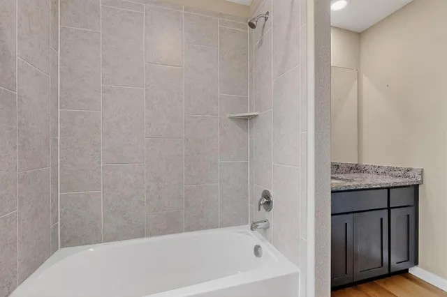 a bathroom with a bathtub and a shower