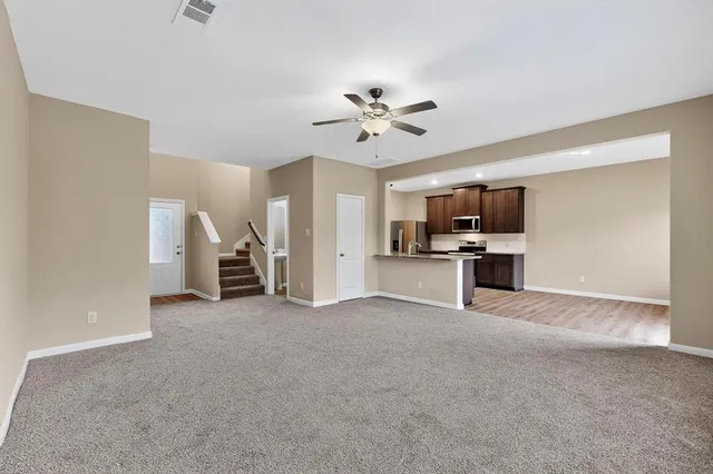 a view of a kitchen with a sink a kitchen a refrigerator and a stove top oven