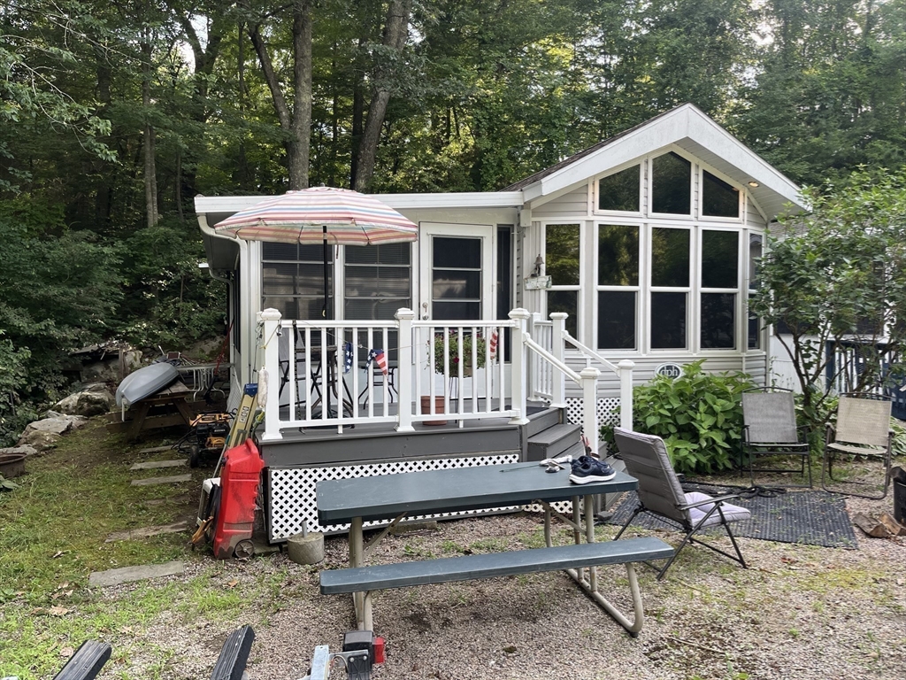 262 Shetucket Turnpike, Unit 112 Griswold, CT 06351 - Photo 1 of 25 a view of a house with a yard and sitting area