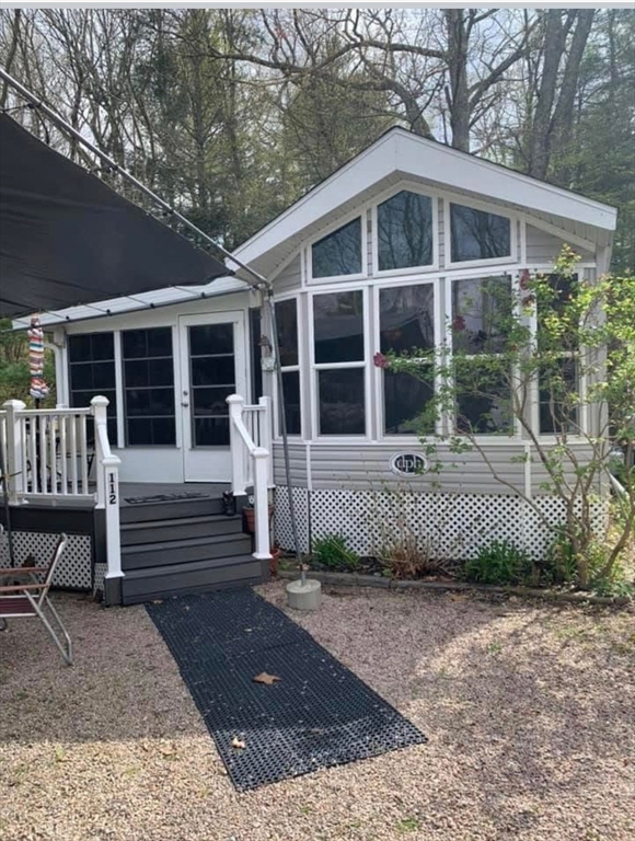 262 Shetucket Turnpike, Unit 112 Griswold, CT 06351 - Photo 19 of 25 a front view of a house with a yard