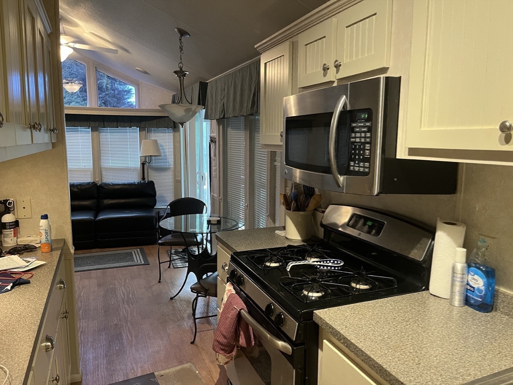 262 Shetucket Turnpike, Unit 112 Griswold, CT 06351 - Photo 4 of 25 a kitchen with a stove and a refrigerator