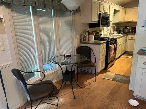a kitchen with stainless steel appliances kitchen island granite countertop dining room cabinets and granite counter tops
